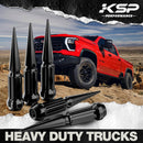 Black spike lug nuts by KSP Performance displayed in front of a red off-road heavy-duty truck on rocky terrain. The lug nuts are designed for durability and aggressive styling, ideal for trucks and lifted vehicles. Bold 'Heavy Duty Trucks' text emphasizes rugged use.