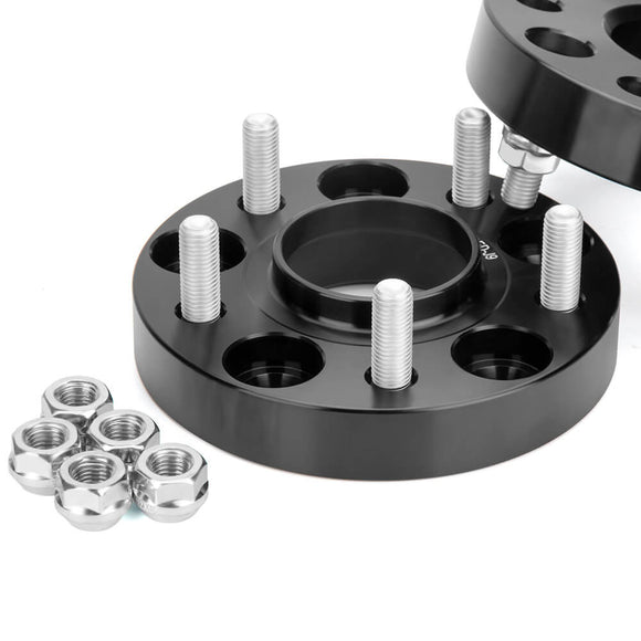 Clean product shot of two matte black hubcentric wheel spacers with high-strength bolts, accompanied by a pile of silver lug nuts for installation.